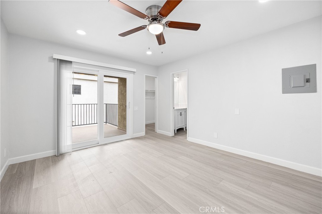 114 10th Street, Unit C Huntington Beach, CA 92648 - Photo 9 of 21 an empty room with wooden floor ceiling fan and windows
