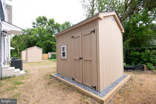 a view of backyard with tub and trees
