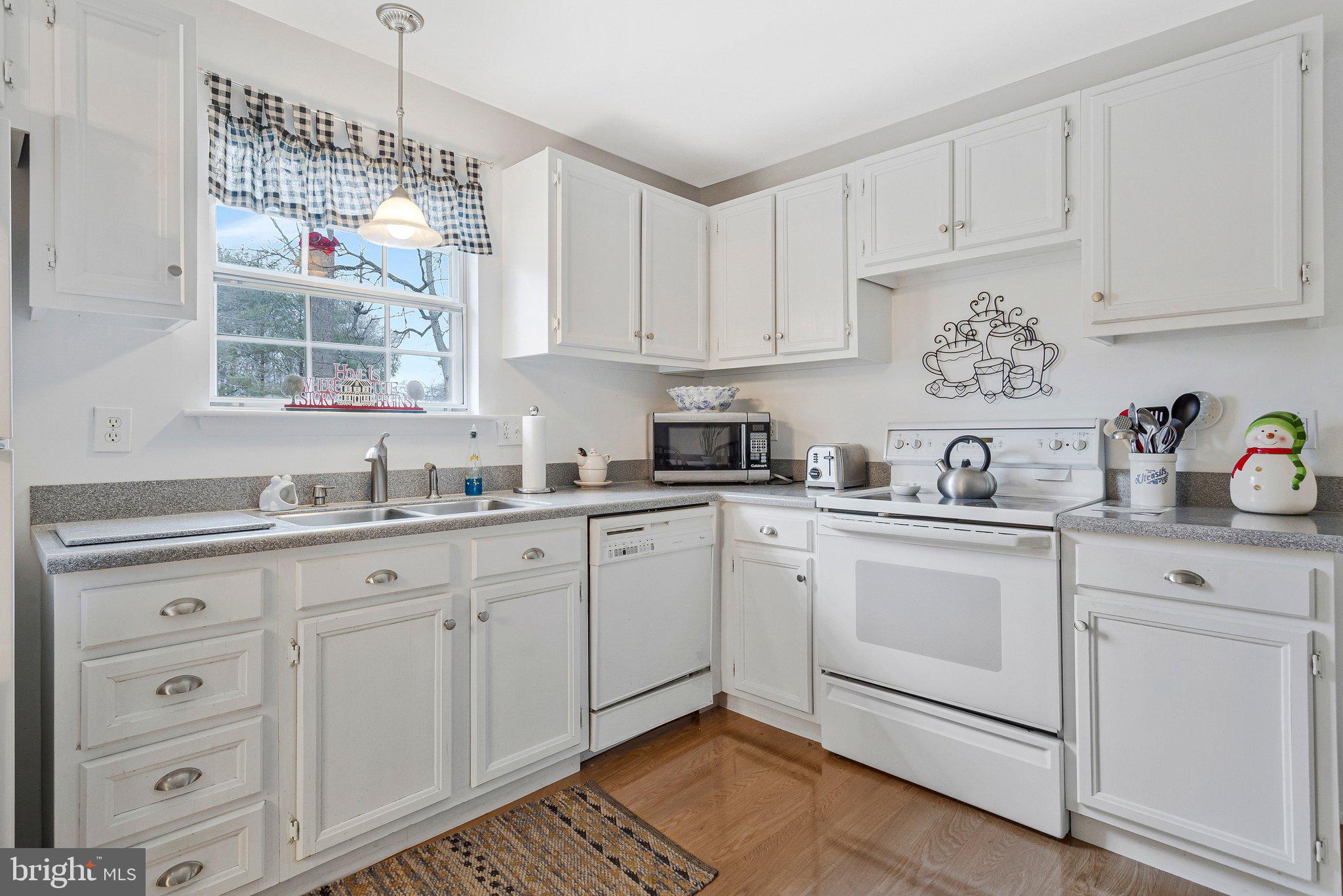 120 Claiborne Road Edgewater, MD 21037 - Photo 5 of 16 a kitchen with granite countertop white cabinets white appliances and sink
