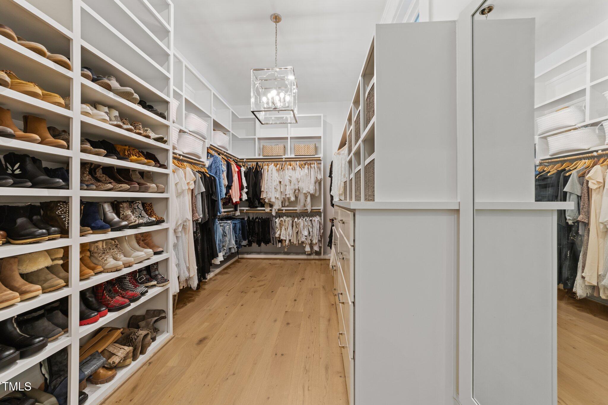 1208 Hunting Ridge Road Raleigh, NC 27615 - Photo 26 of 71 a view of walk in closet with clothes and shoes