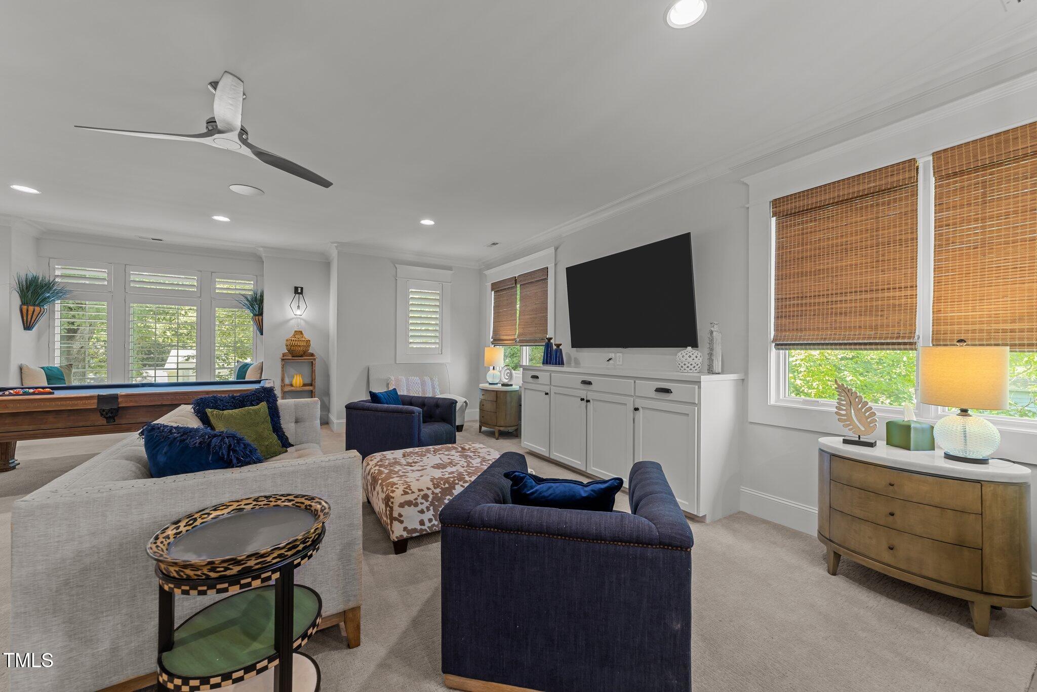 1208 Hunting Ridge Road Raleigh, NC 27615 - Photo 33 of 71 a living room with furniture and a flat screen tv