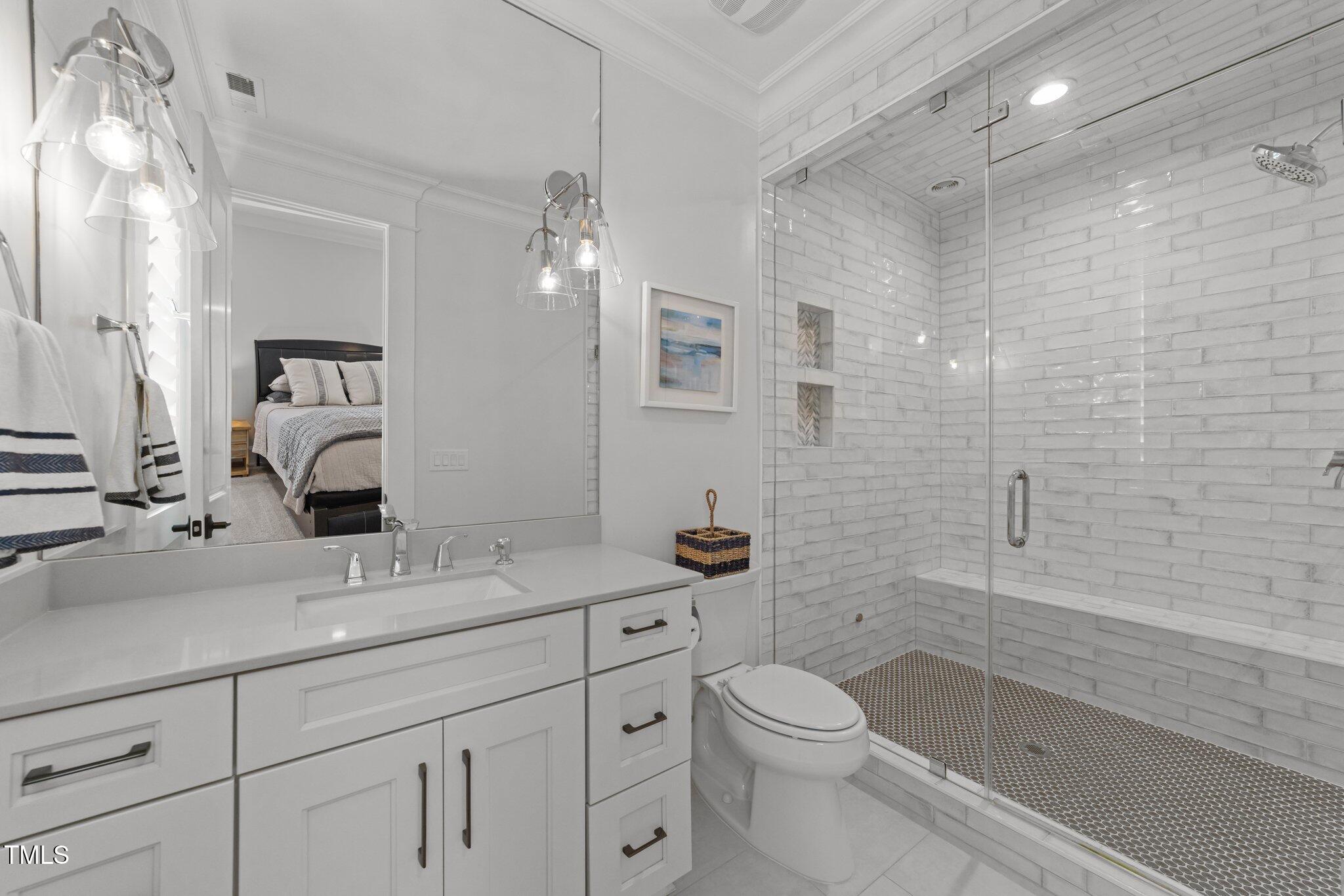 1208 Hunting Ridge Road Raleigh, NC 27615 - Photo 46 of 71 a bathroom with a sink a toilet and shower
