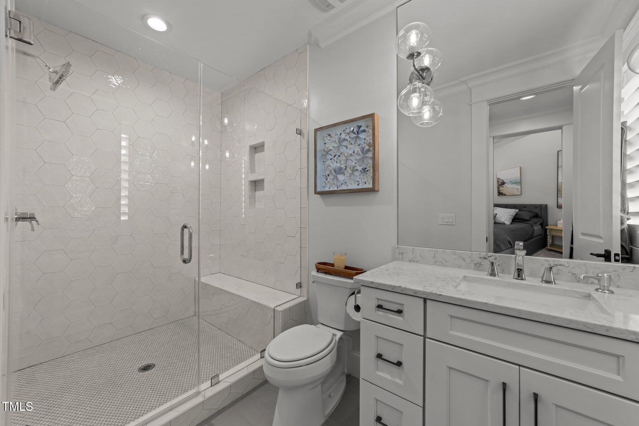 1208 Hunting Ridge Road Raleigh, NC 27615 - Photo 47 of 71 a bathroom with a toilet sink and shower