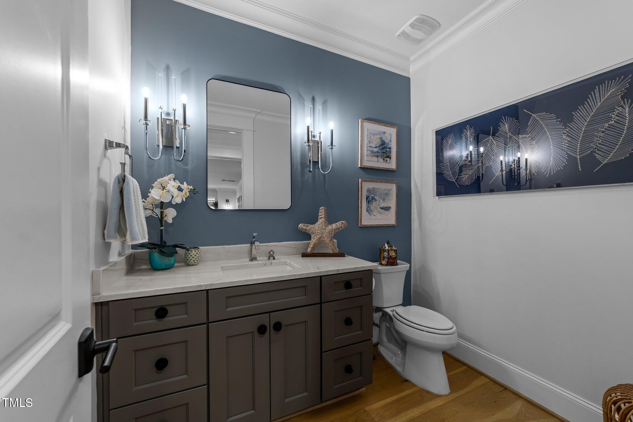 1208 Hunting Ridge Road Raleigh, NC 27615 - Photo 53 of 71 a bathroom with a toilet sink and mirror