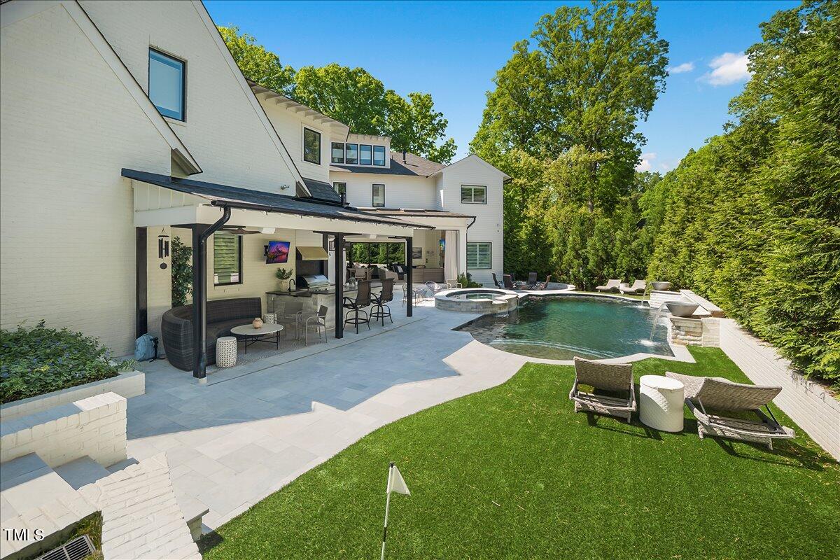 1208 Hunting Ridge Road Raleigh, NC 27615 - Photo 64 of 71 a view of a swimming pool with lawn chairs and a big yard
