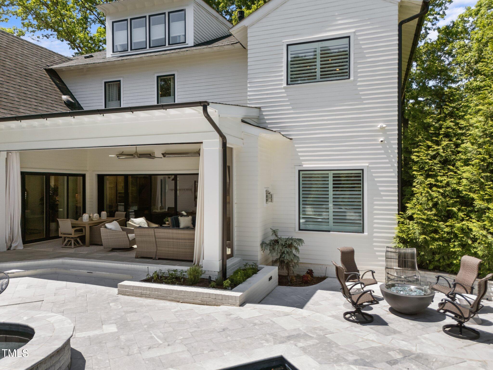 1208 Hunting Ridge Road Raleigh, NC 27615 - Photo 65 of 71 a view of a house with backyard outdoor seating area and a garden