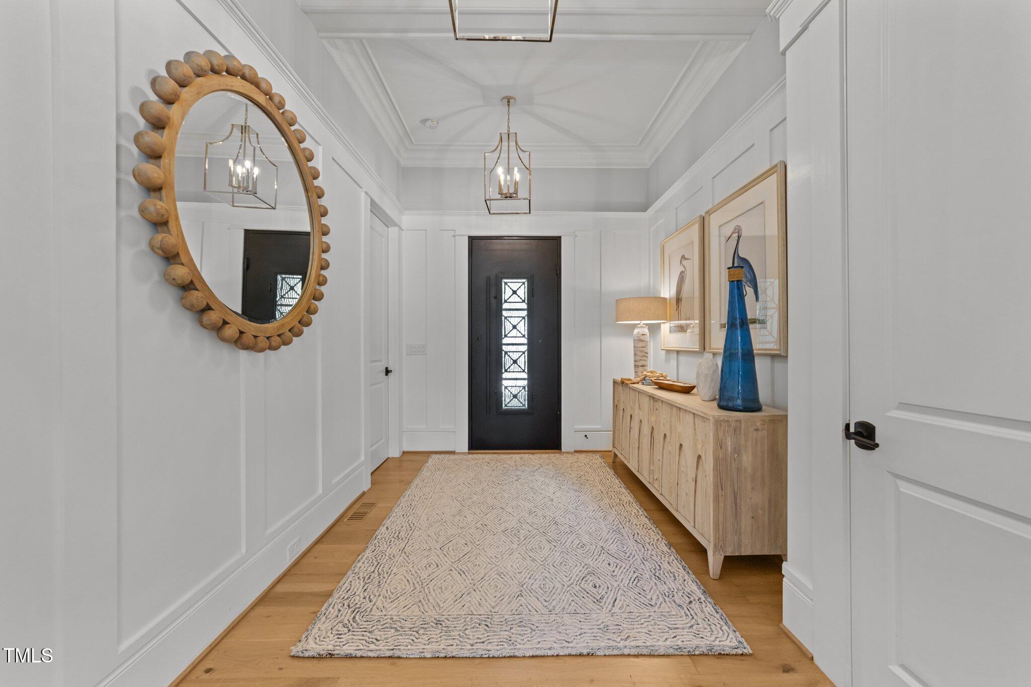 1208 Hunting Ridge Road Raleigh, NC 27615 - Photo 10 of 71 a view of a hallway with wooden floor and a dining room