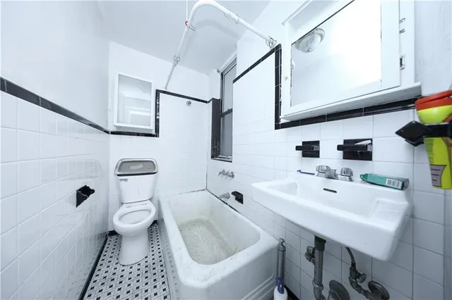 a view of a room with wooden floors and ceiling fan