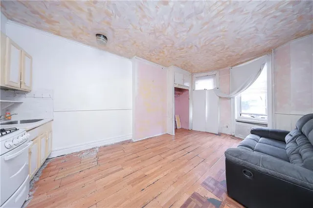 a big room with wooden floor and windows