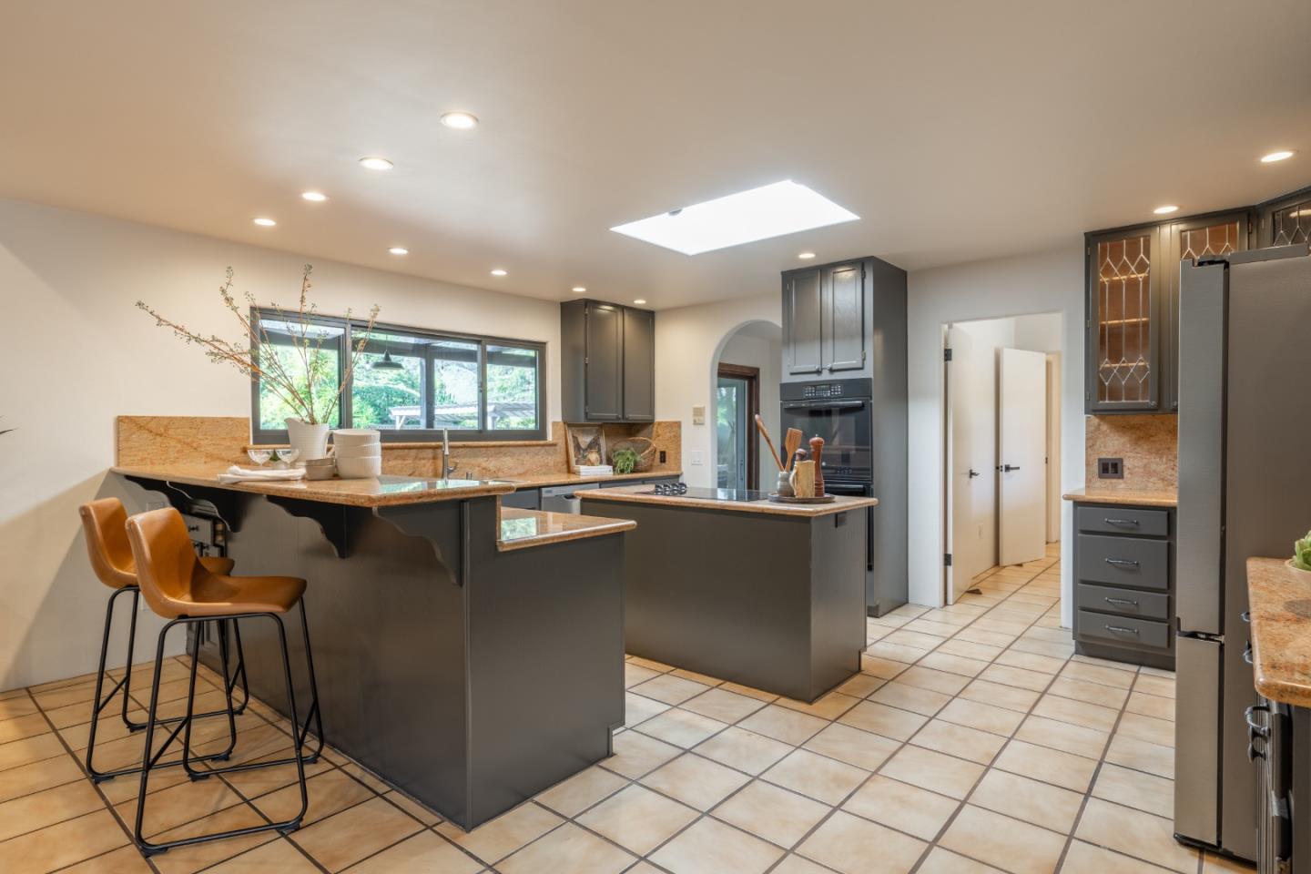 19 El Caminito Road Carmel Valley, CA 93924 - Photo 13 of 50 a kitchen with stainless steel appliances kitchen island granite countertop a refrigerator and a stove top oven
