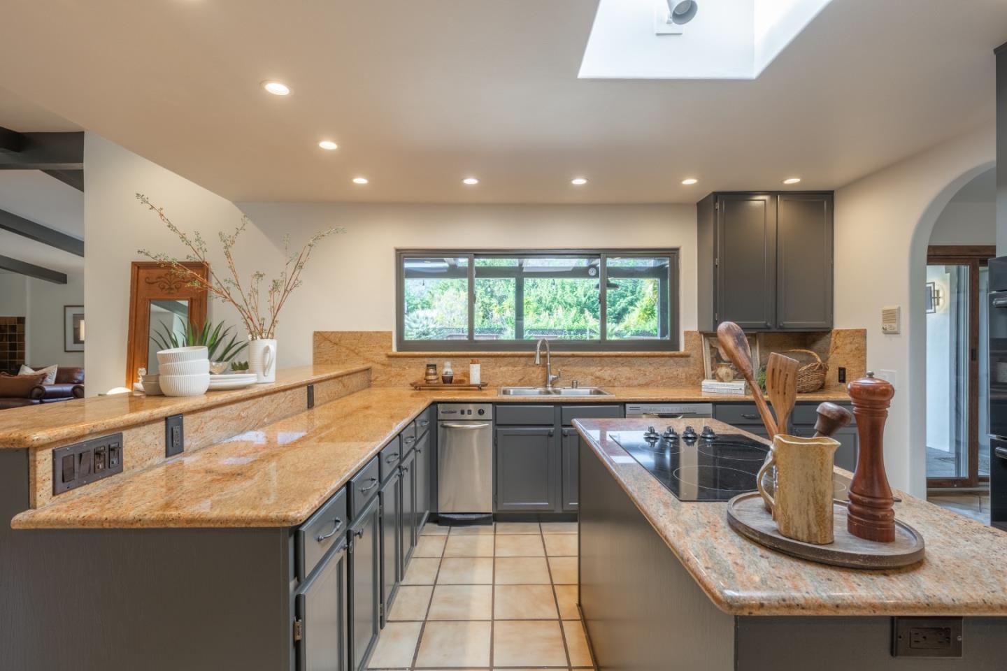 19 El Caminito Road Carmel Valley, CA 93924 - Photo 14 of 50 a kitchen with sink a window and chairs