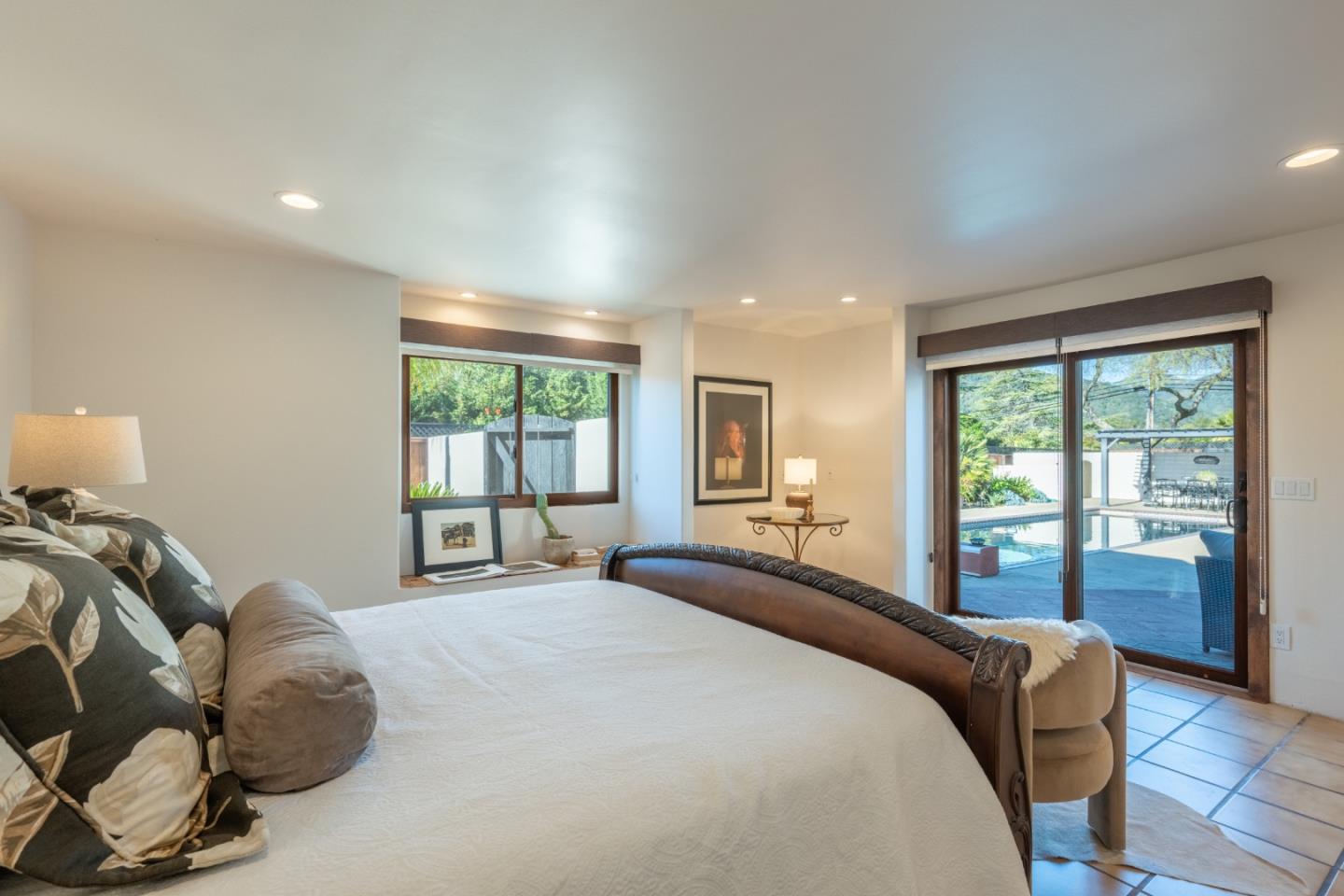 19 El Caminito Road Carmel Valley, CA 93924 - Photo 21 of 50 a bedroom with a large bed and a large window