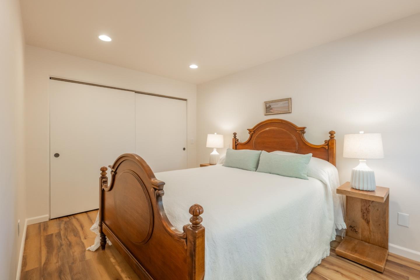 19 El Caminito Road Carmel Valley, CA 93924 - Photo 23 of 50 a bedroom with a bed and a lamp