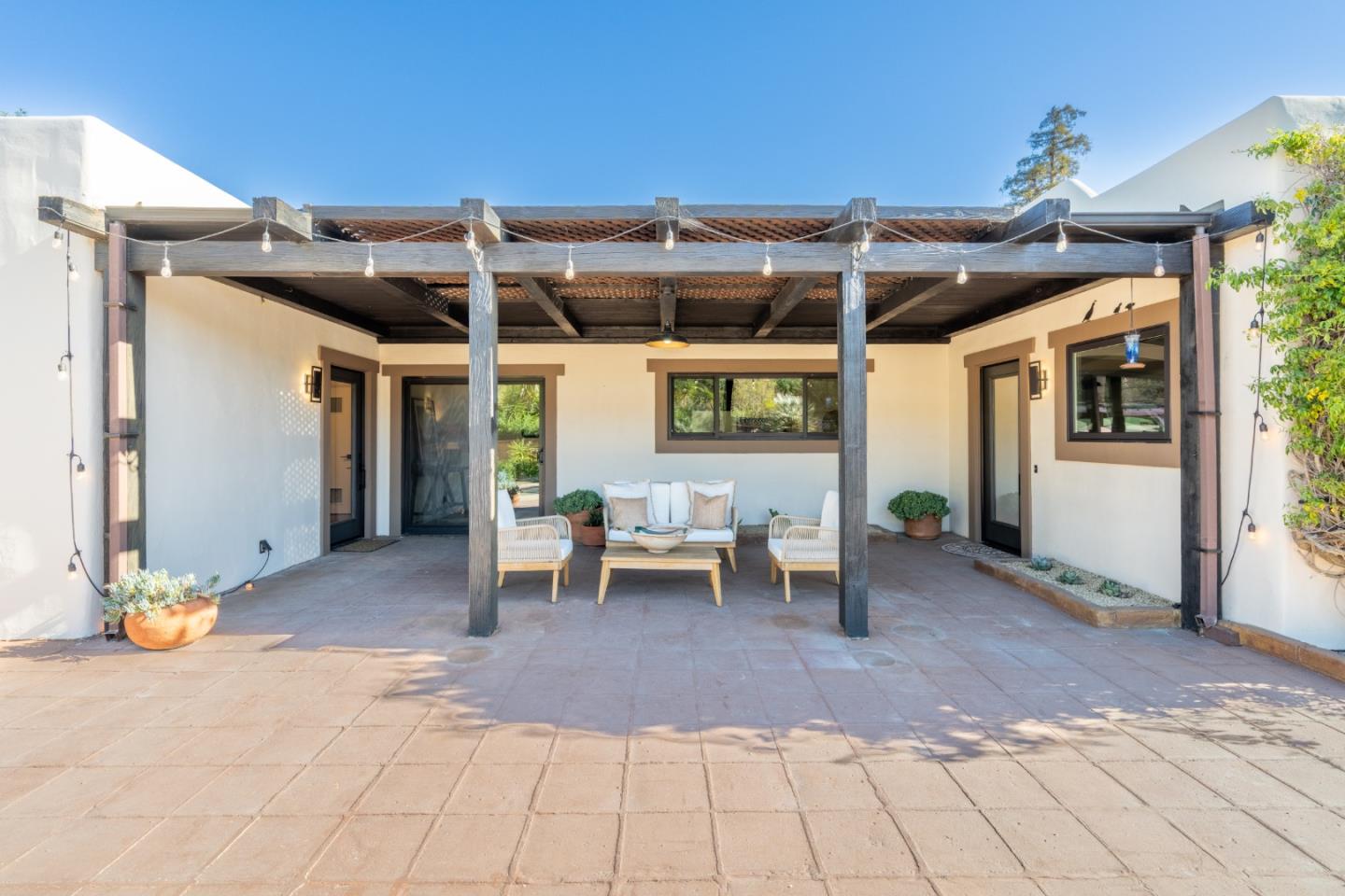 19 El Caminito Road Carmel Valley, CA 93924 - Photo 33 of 50 a view of a patio with a table and chairs under an umbrella