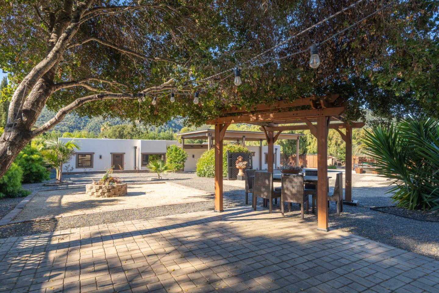 19 El Caminito Road Carmel Valley, CA 93924 - Photo 36 of 50 a view of a backyard with table and chairs under an umbrella