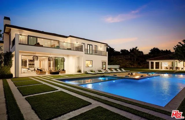 a front view of a house with swimming pool having outdoor seating