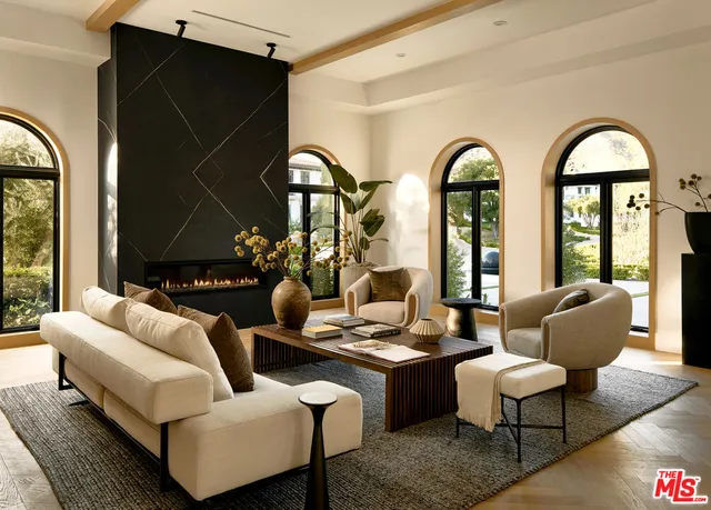 a living room with couches a coffee table and four couches with wooden floor