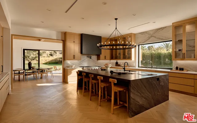 a kitchen with lots of counter top space and dining table