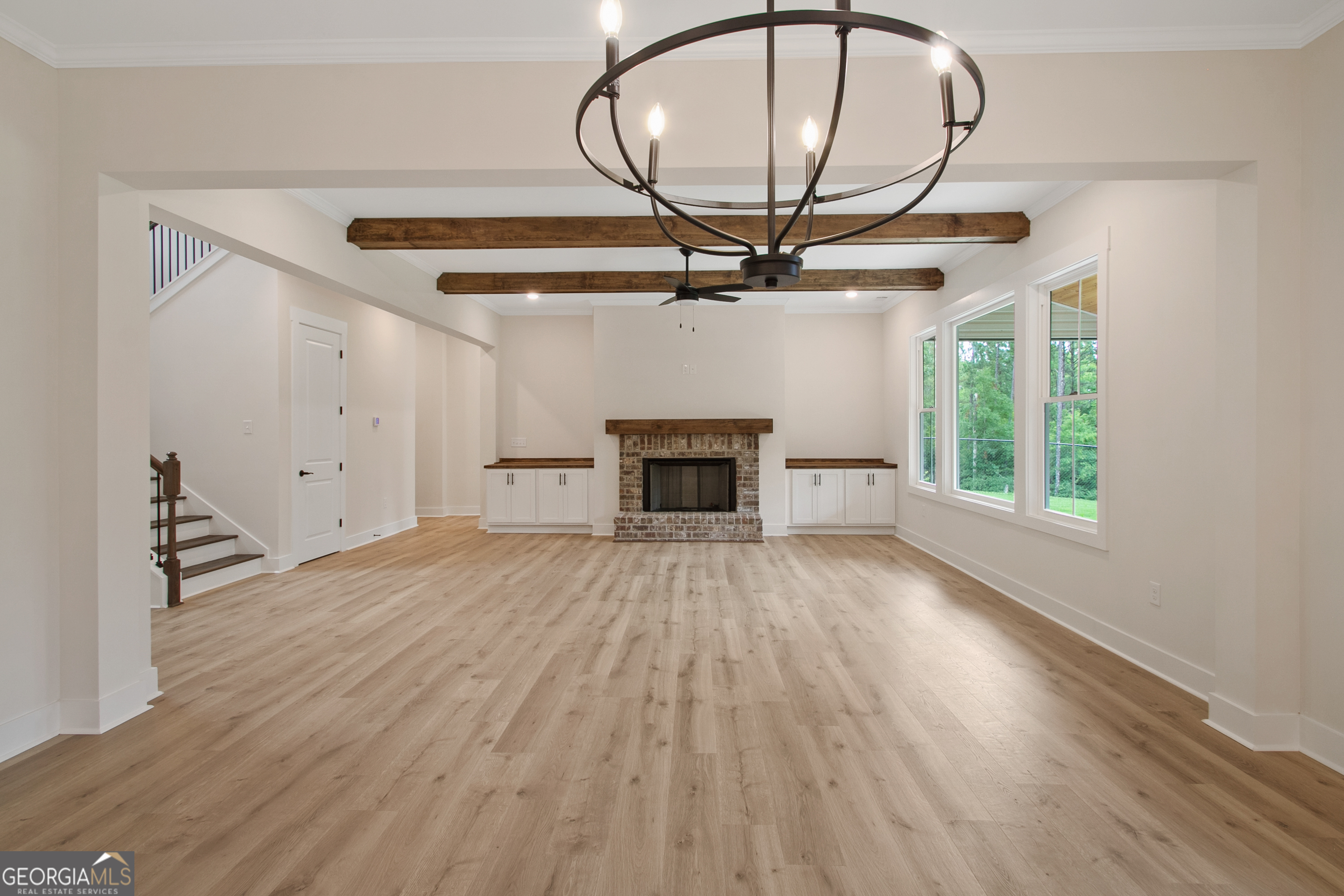312 Clover Pass Forsyth, GA 31029 - Photo 14 of 22 a view of an empty room with a fireplace and a window