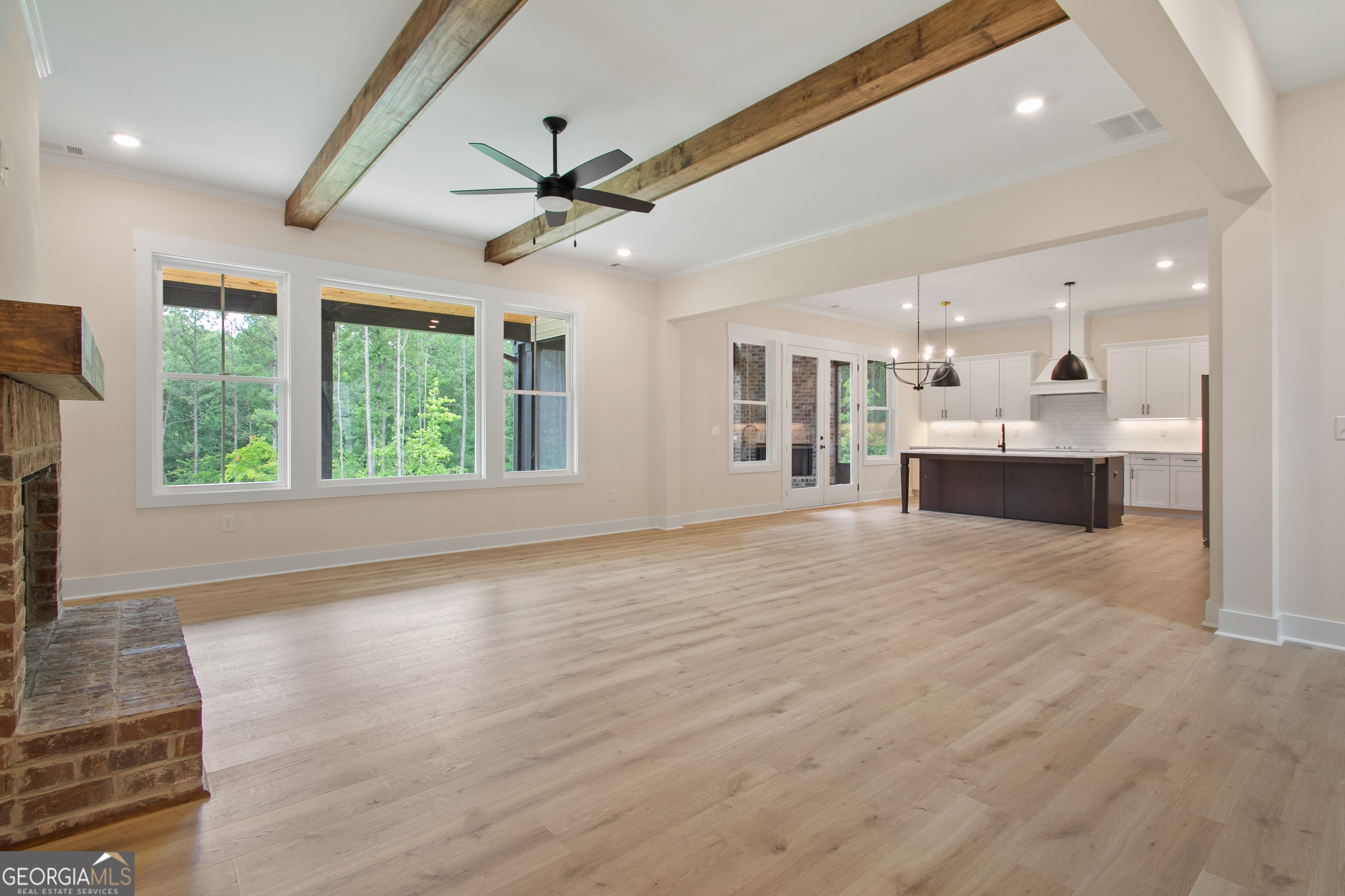 312 Clover Pass Forsyth, GA 31029 - Photo 15 of 22 a view of an empty room with wooden floor and a window