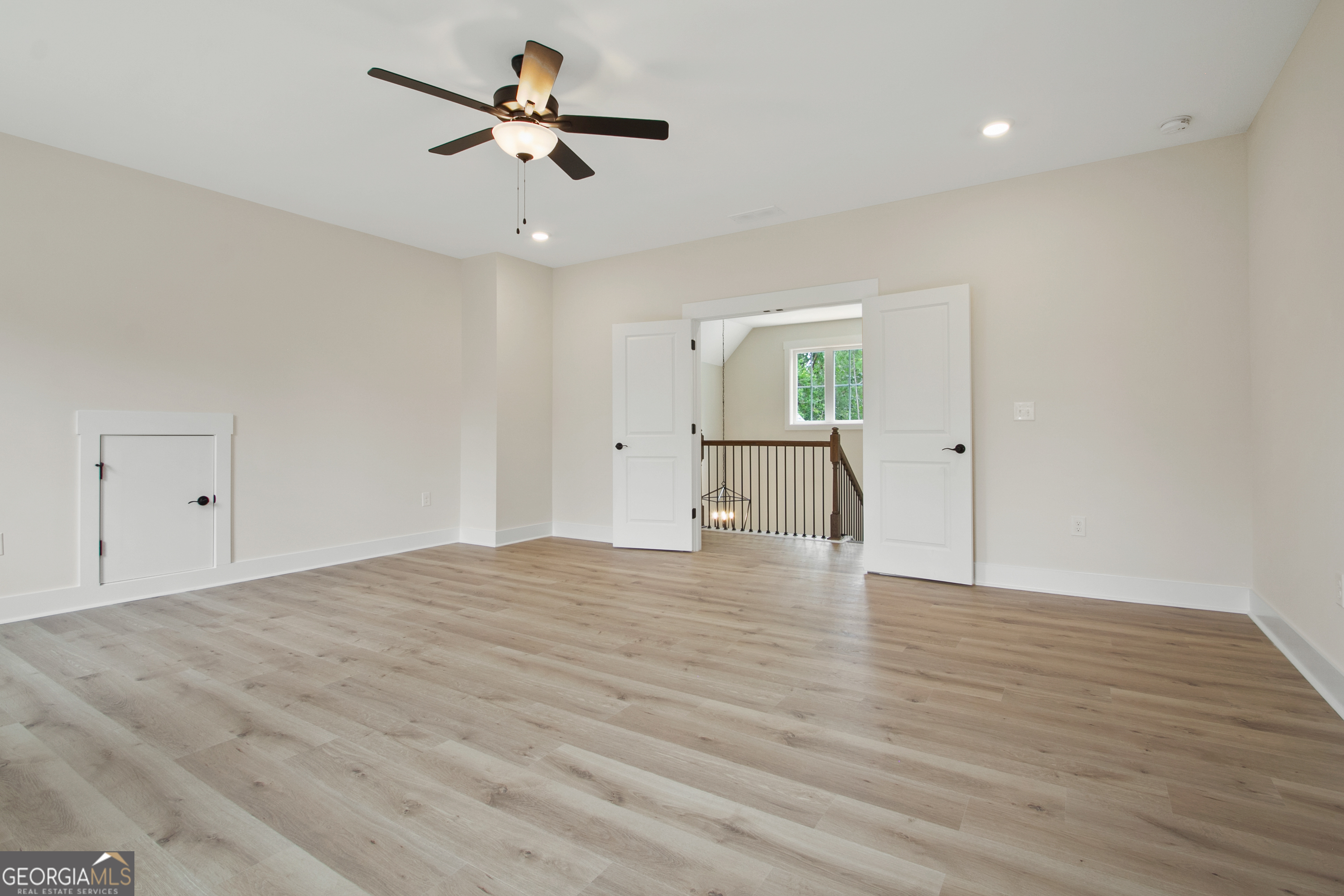 312 Clover Pass Forsyth, GA 31029 - Photo 16 of 22 a view of empty room with wooden floor and fan