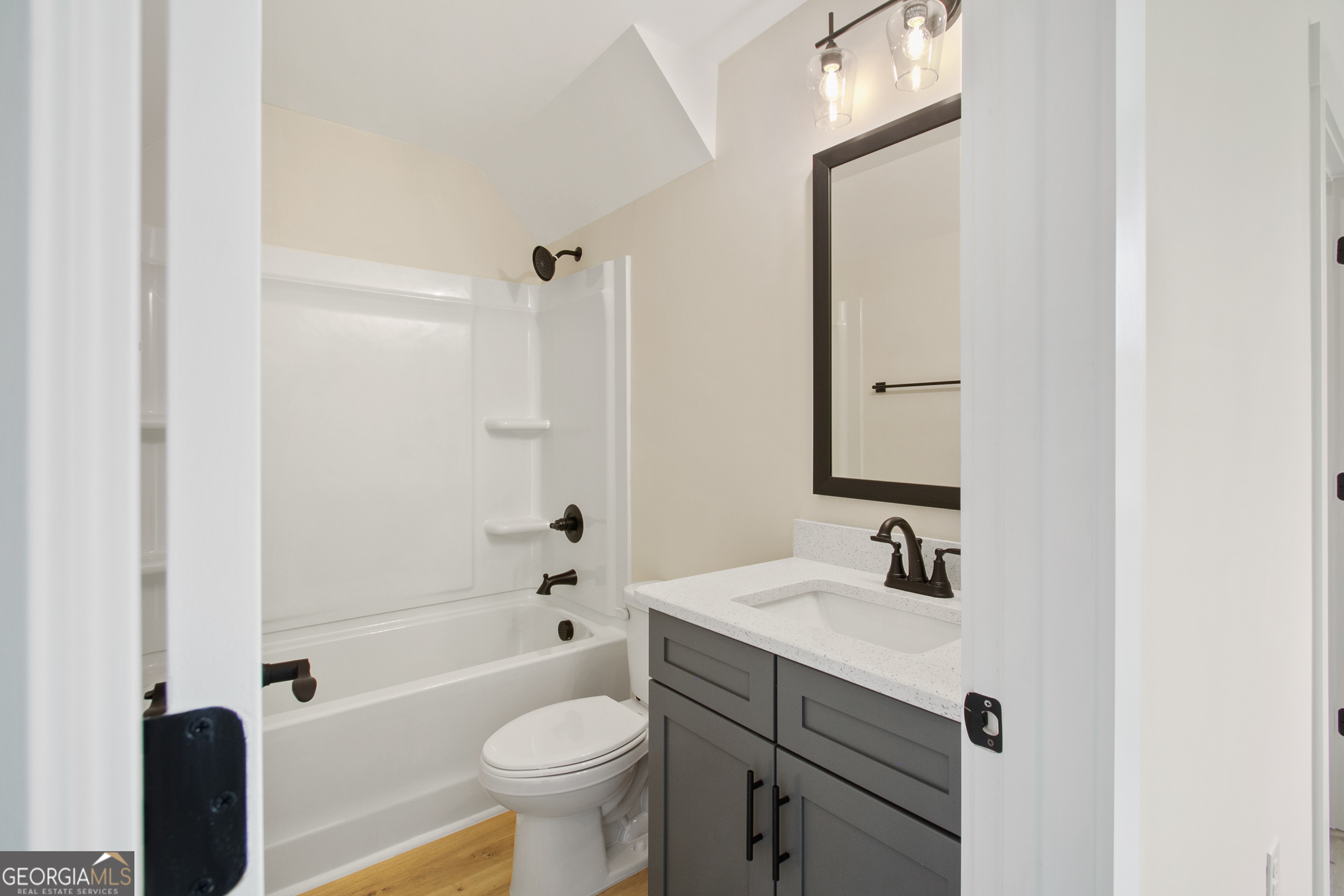 312 Clover Pass Forsyth, GA 31029 - Photo 17 of 22 a bathroom with a sink toilet and shower