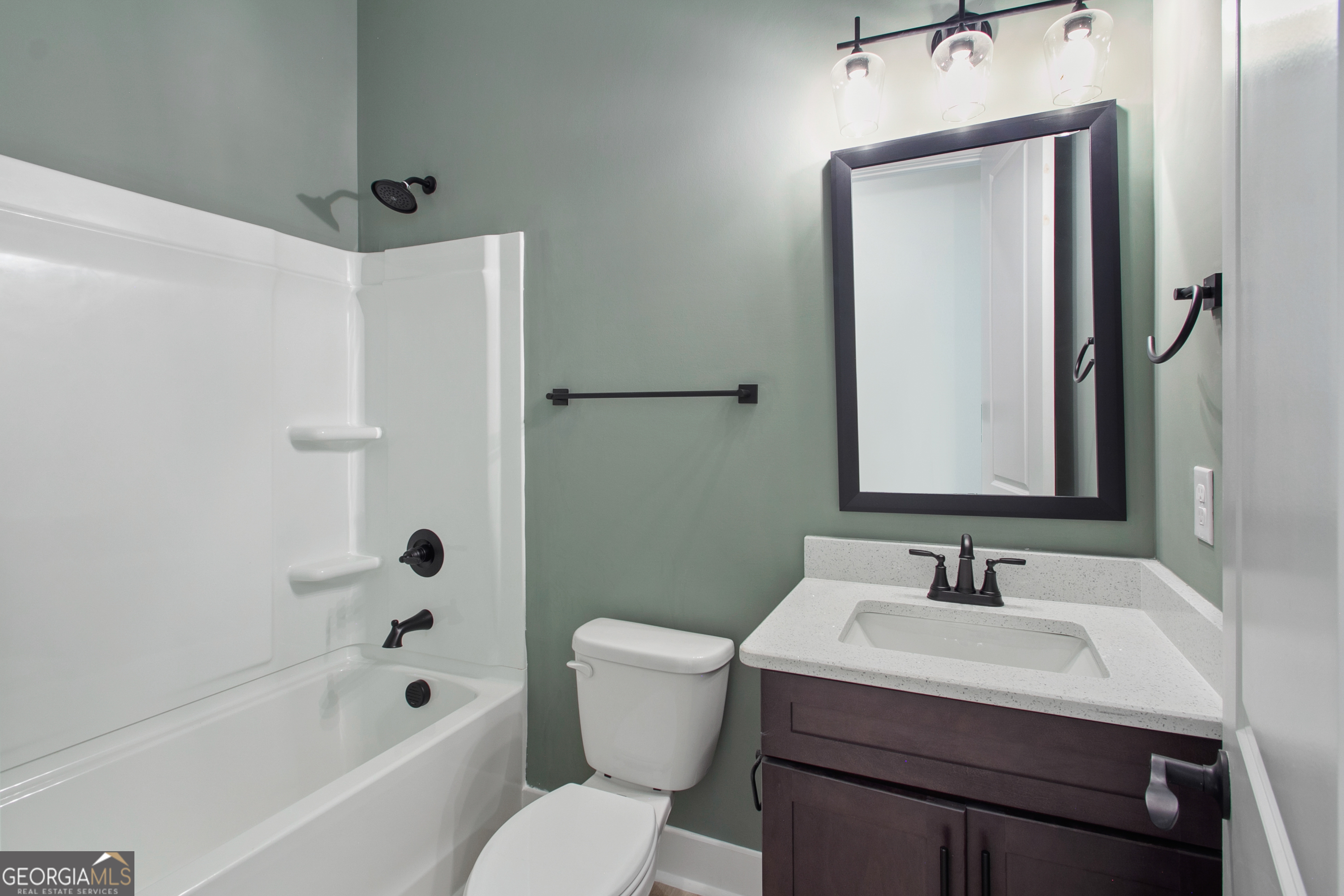 312 Clover Pass Forsyth, GA 31029 - Photo 18 of 22 a bathroom with a sink a toilet and shower