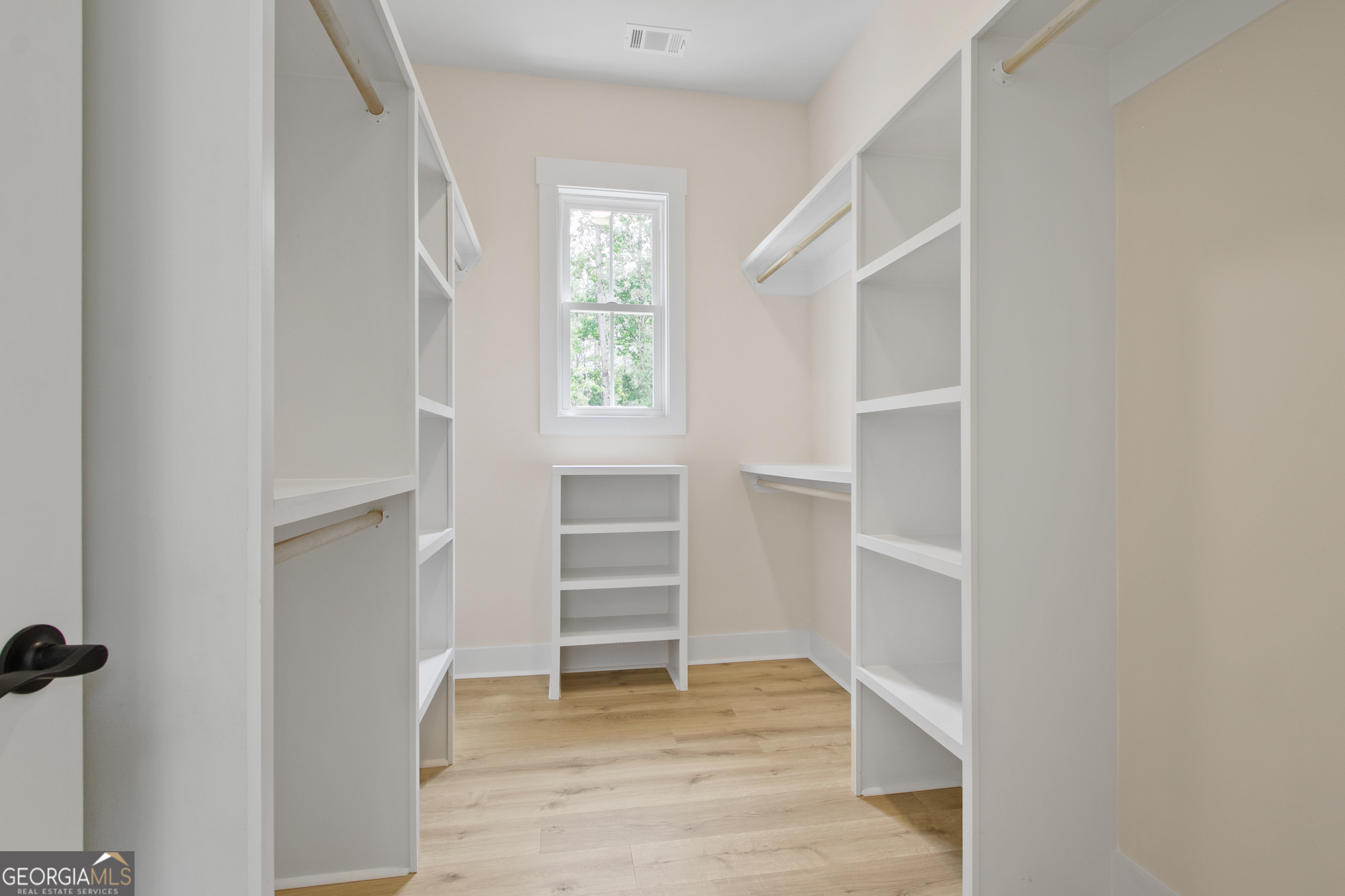 312 Clover Pass Forsyth, GA 31029 - Photo 21 of 22 a view of walk in closet with empty racks