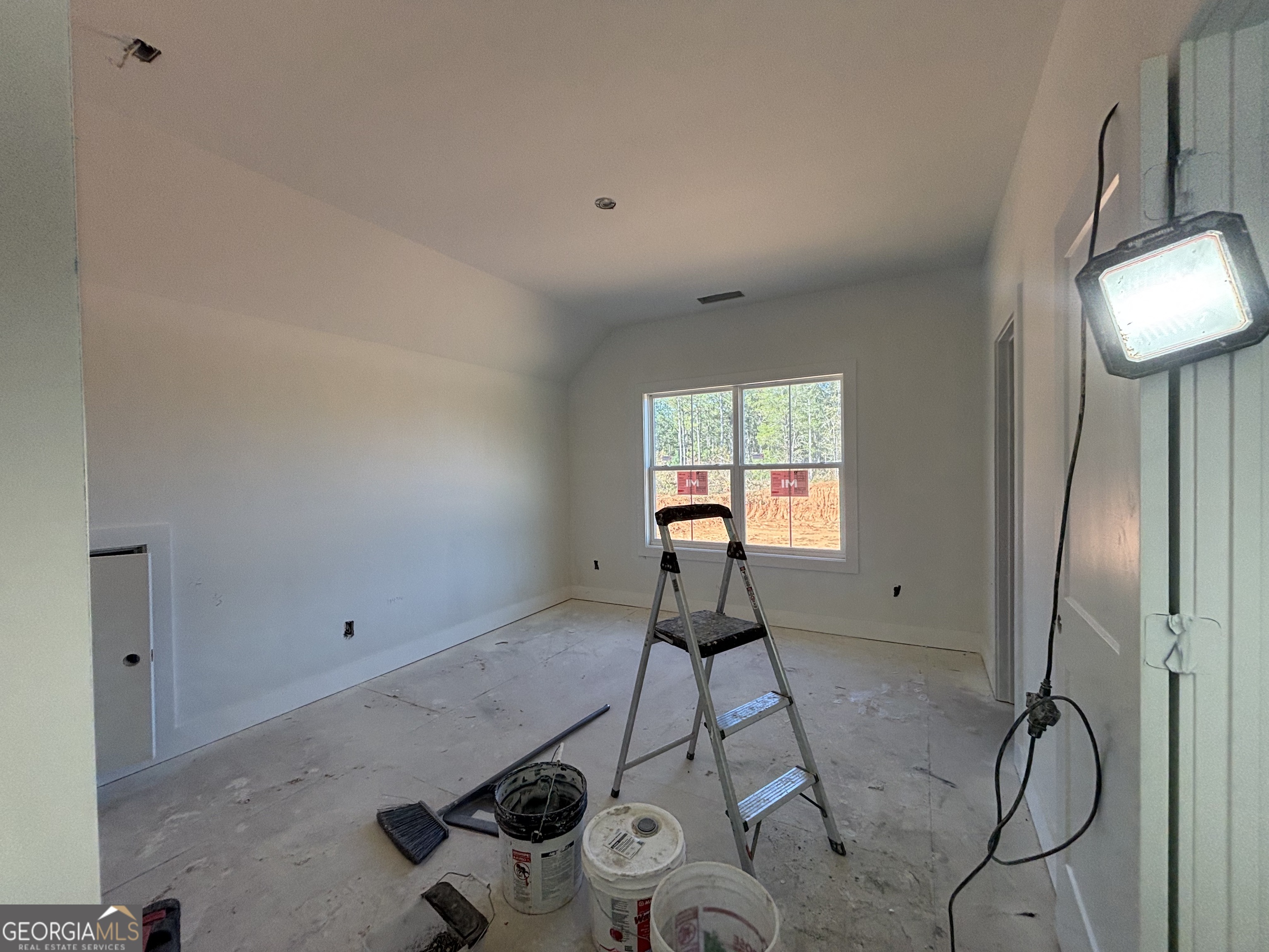 312 Clover Pass Forsyth, GA 31029 - Photo 9 of 22 a view of a room with rack on the wall and a window