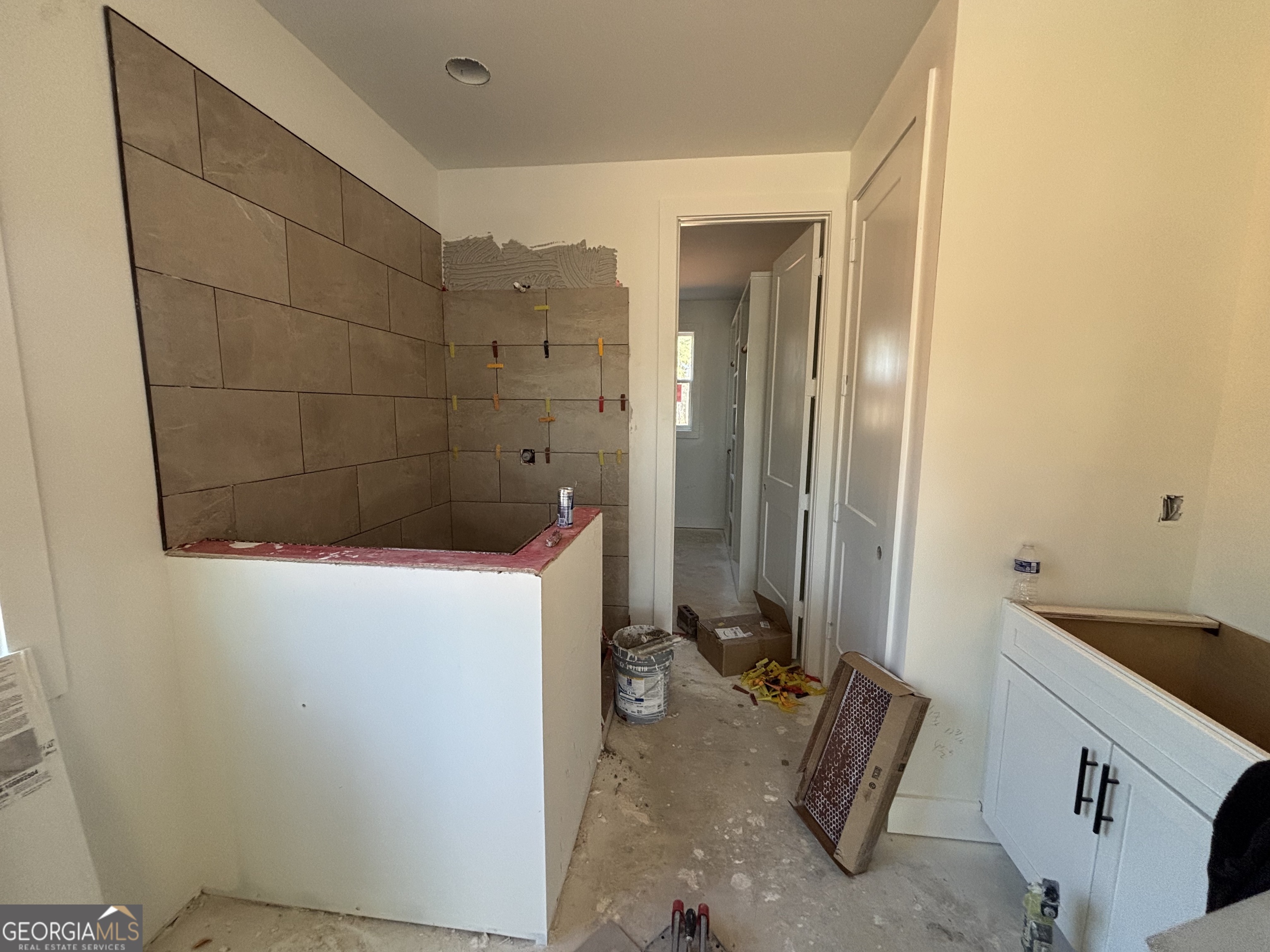 312 Clover Pass Forsyth, GA 31029 - Photo 10 of 22 a bathroom with a sink and a shower