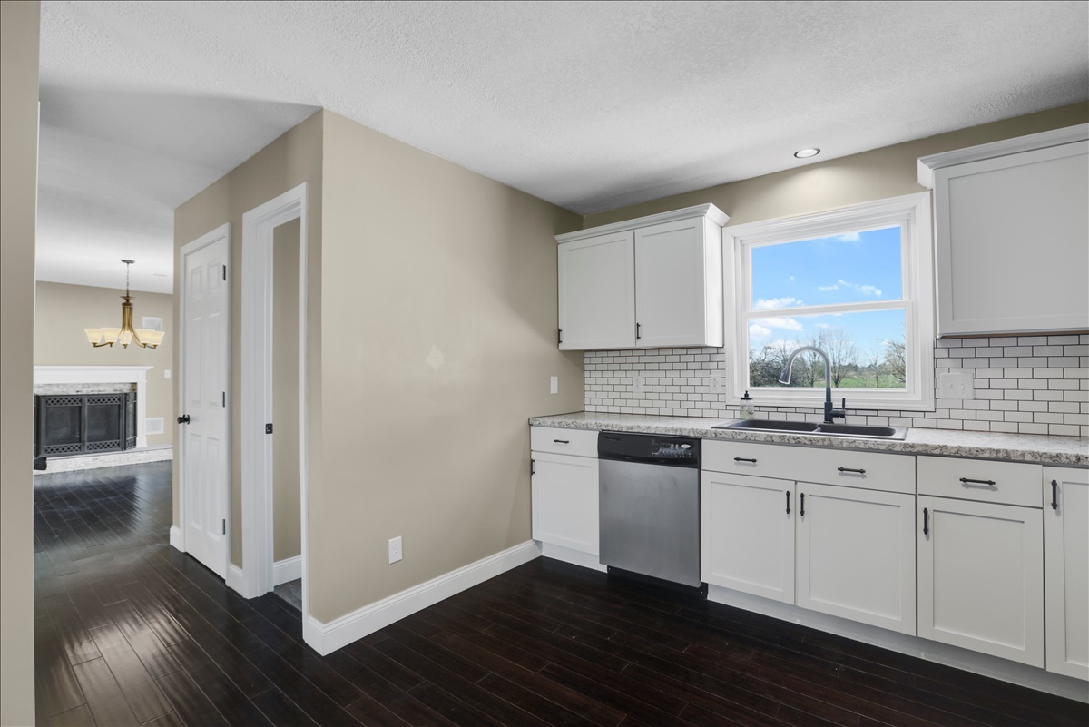17105 Clinton Road Danville, IL 61834 - Photo 12 of 31 a kitchen with granite countertop white cabinets and white appliances