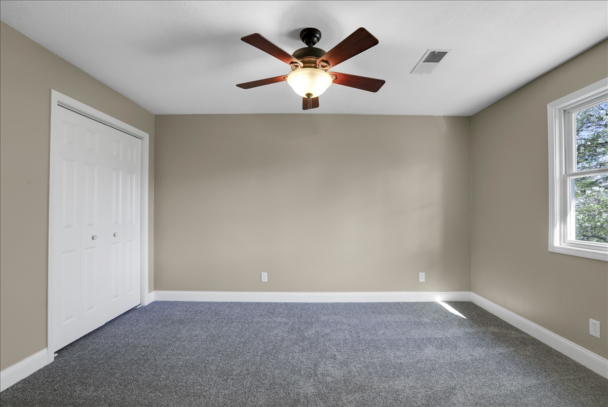 17105 Clinton Road Danville, IL 61834 - Photo 18 of 31 an empty room with window and ceiling fan
