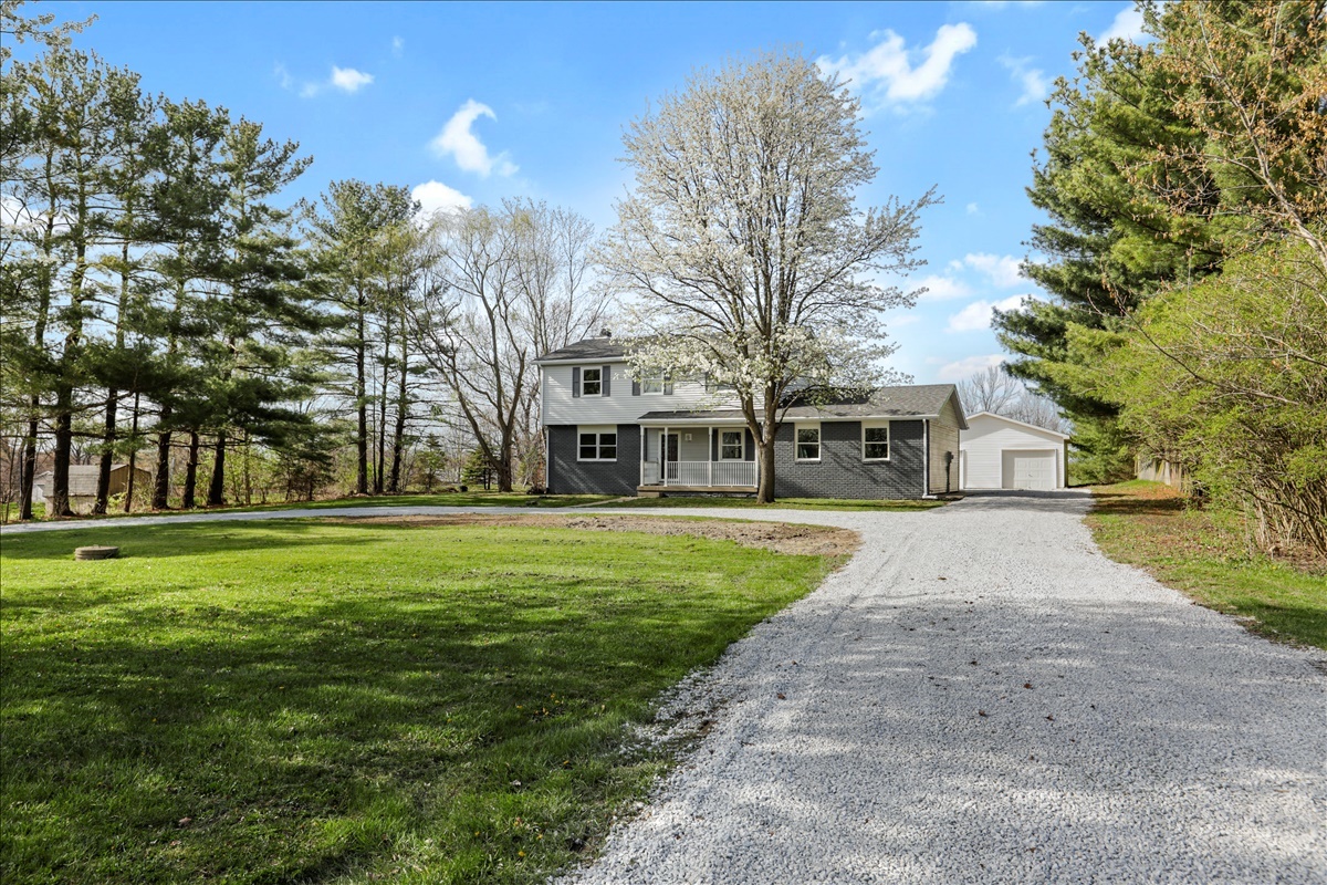 17105 Clinton Road Danville, IL 61834 - Photo 2 of 31 a view of a white house in front of a big yard with large trees