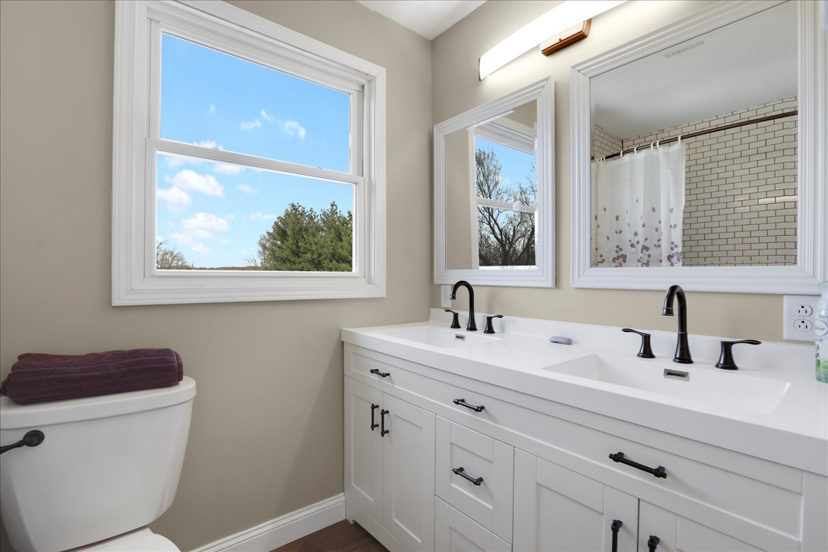 17105 Clinton Road Danville, IL 61834 - Photo 22 of 31 a bathroom with a toilet sink and mirror