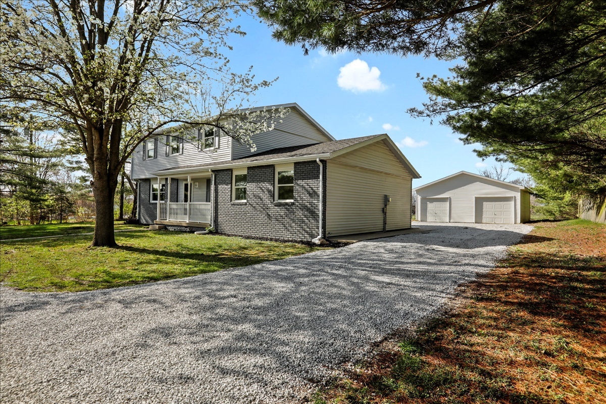 17105 Clinton Road Danville, IL 61834 - Photo 3 of 31 a front view of a house with a yard and garage