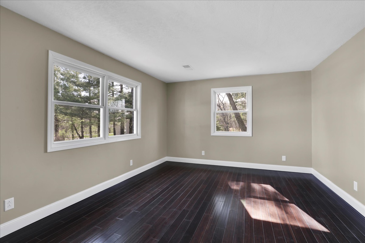 17105 Clinton Road Danville, IL 61834 - Photo 5 of 31 a view of an empty room with wooden floor and a window