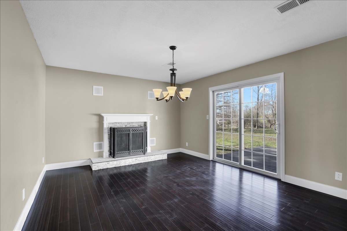 17105 Clinton Road Danville, IL 61834 - Photo 7 of 31 a view of wooden floor chandelier and window in a room