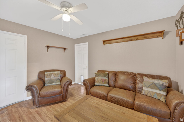 1464 990 West Provo, UT 84601 - Photo 27 of 41 Living area featuring wood-finish flooring, two panel doors, and a ceiling fan with integrated lighting