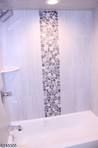 a bathroom with a bathtub and shower