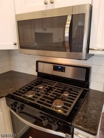 a stove top oven sitting inside of a kitchen