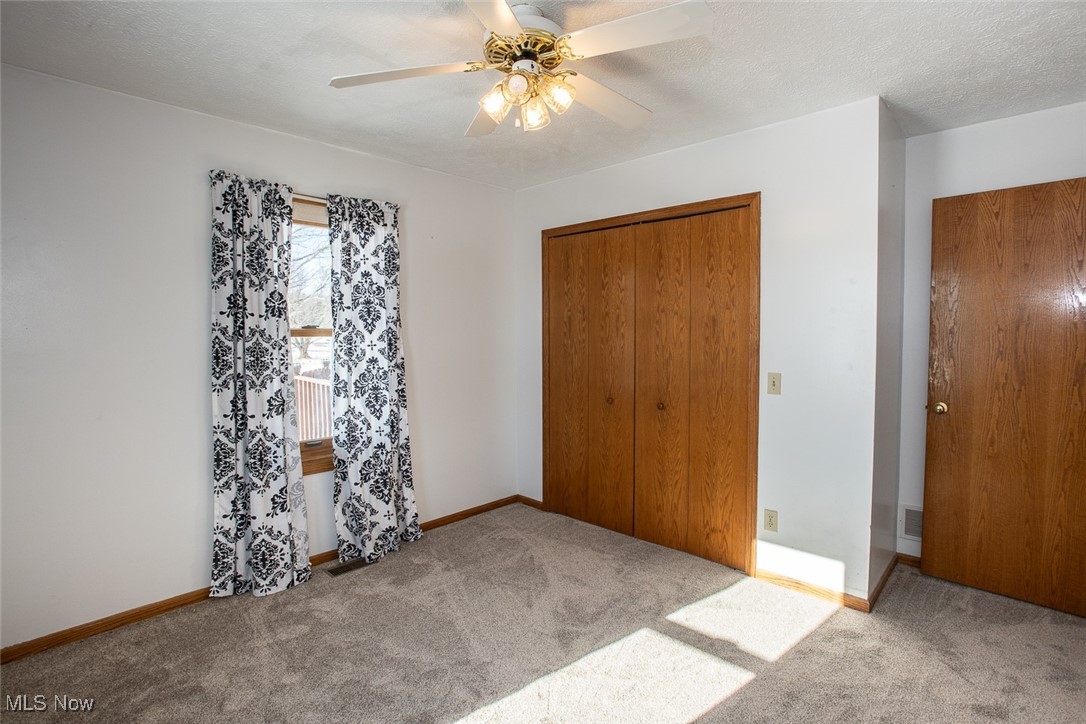 2624 Lester Road Medina, OH 44256 - Photo 33 of 50 Bedroom with newer carpet, large closet and ceiling fan