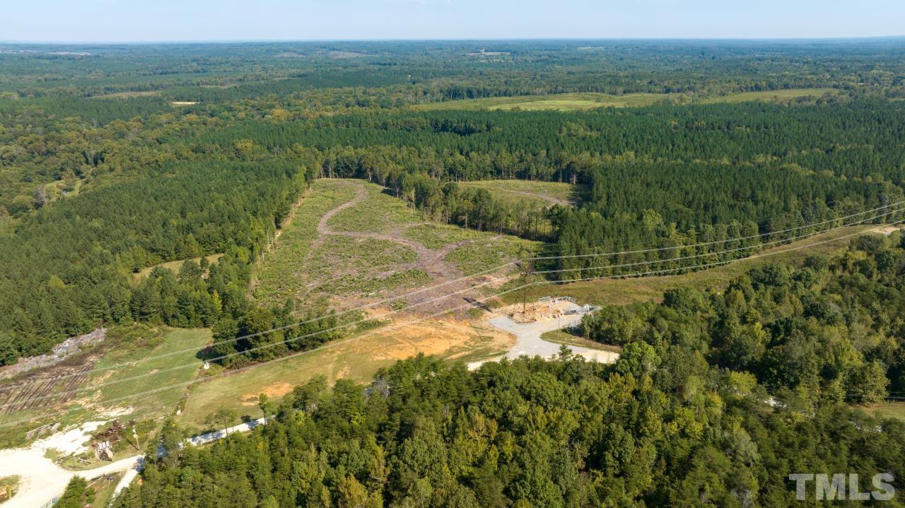 1050 Lawson Farm Road Roxboro, NC 27574 - Photo 15 of 19 a view of a grassy area with an trees