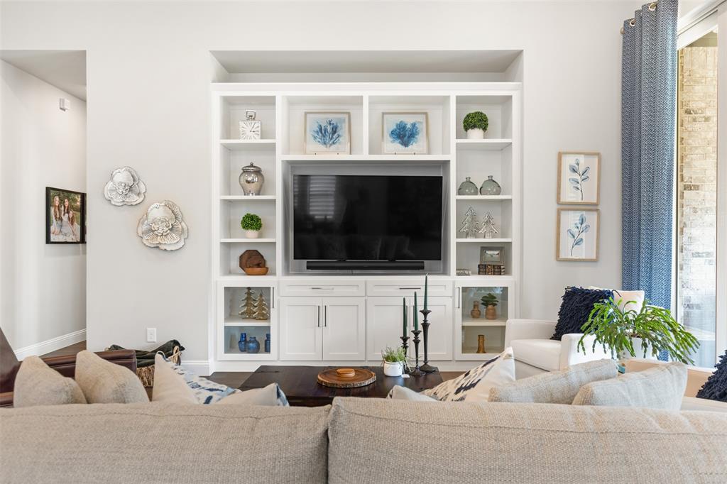 9716 Wilderness Road Little Elm, TX 75068 - Photo 16 of 39 Living room with integrated built-in cabinetry, wood-finish flooring, recessed lighting, and large sliding glass doors