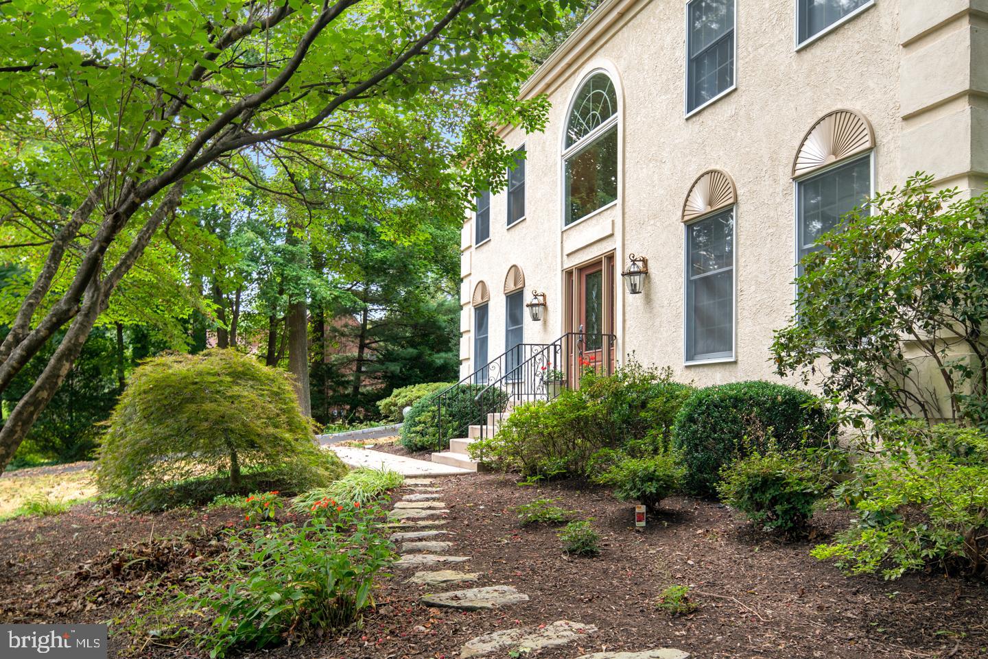 205 Pembroke Road Wallingford, PA 19086 - Photo 3 of 43 a view of a white house with a yard and plants
