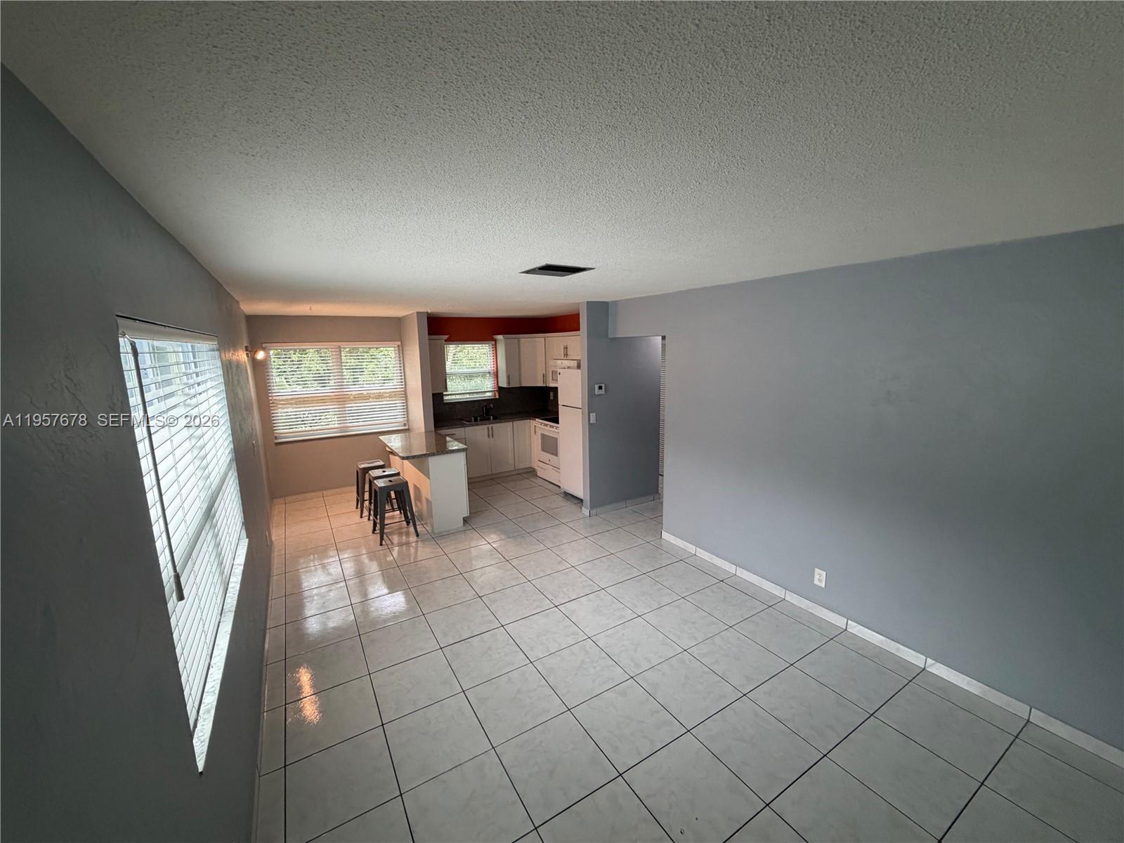 1301 North 12th Court, Unit 4B Hollywood, FL 33019 - Photo 4 of 27 an empty room with fireplace and windows