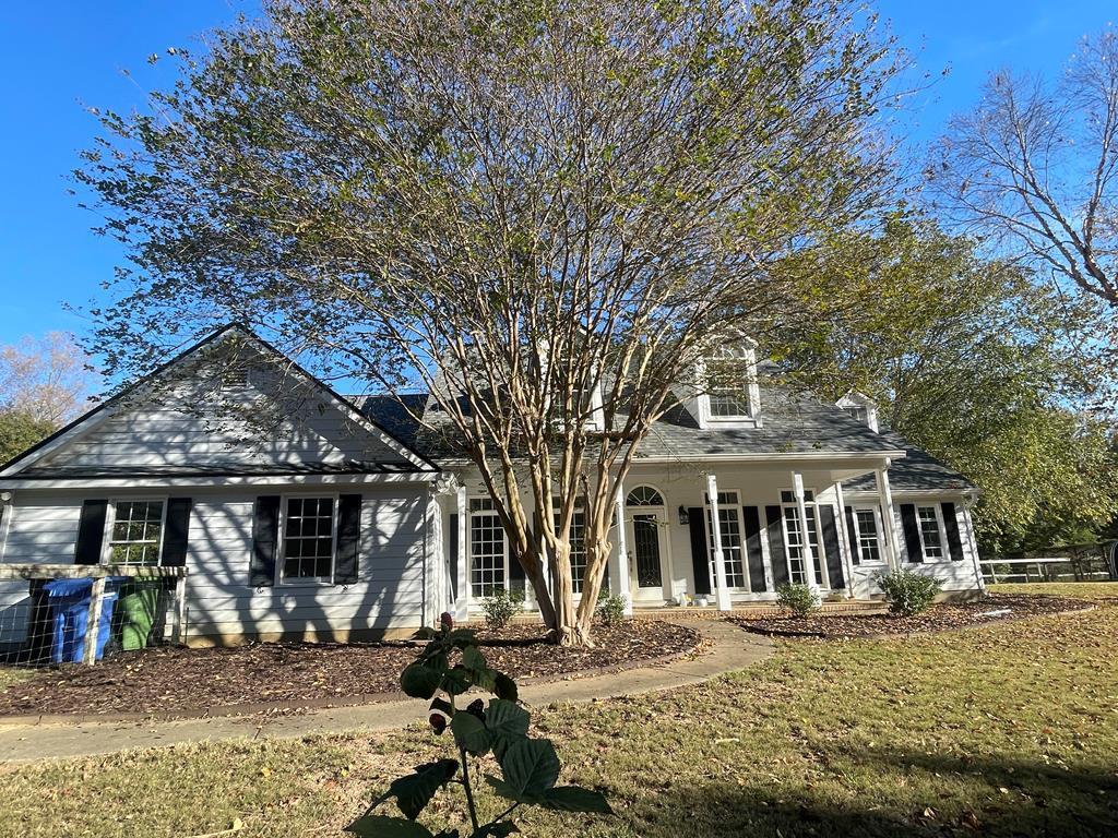 a front view of a house with garden