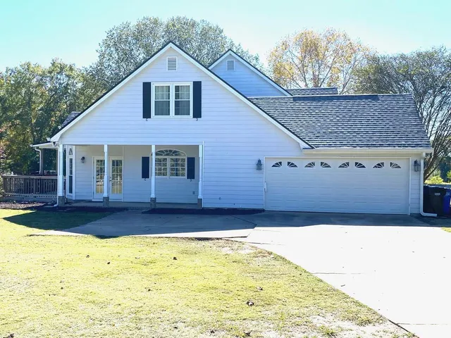 a view of a house with pool and yard