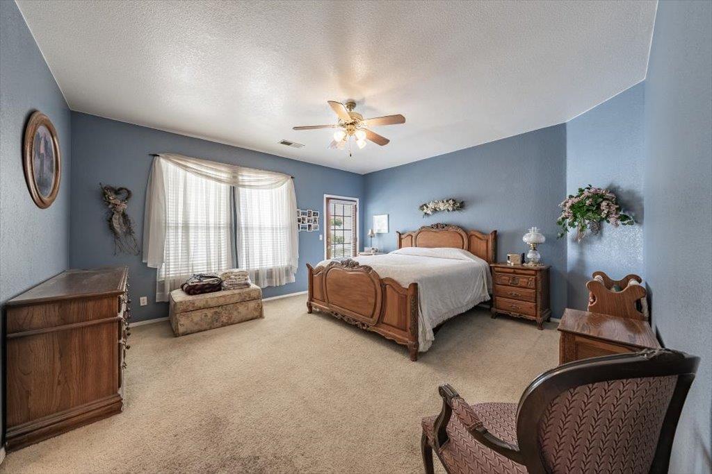 3159 Cedar Creek Lane Madera, CA 93637 - Photo 16 of 37 a spacious bedroom with a bed and window