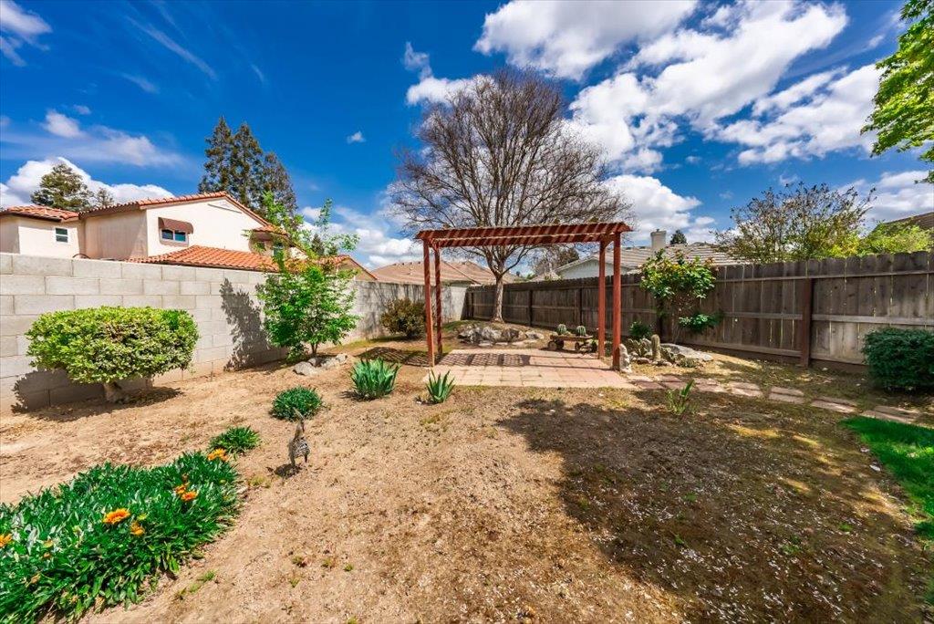 3159 Cedar Creek Lane Madera, CA 93637 - Photo 27 of 37 a view of a backyard with tree s