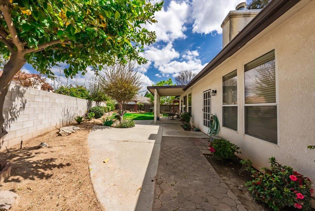 3159 Cedar Creek Lane Madera, CA 93637 - Photo 30 of 37 a view of a backyard with potted plants